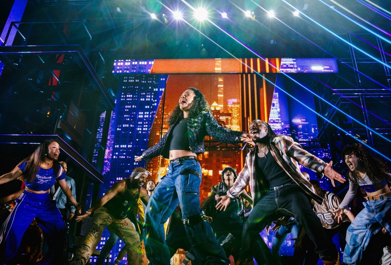 A dynamic concert scene with a singer performing energetically on stage, surrounded by vibrant lights and an enthusiastic crowd reaching towards the stage.